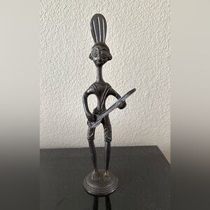 Dhokra Figurine of a Musician Playing a String Instrument. Made in India